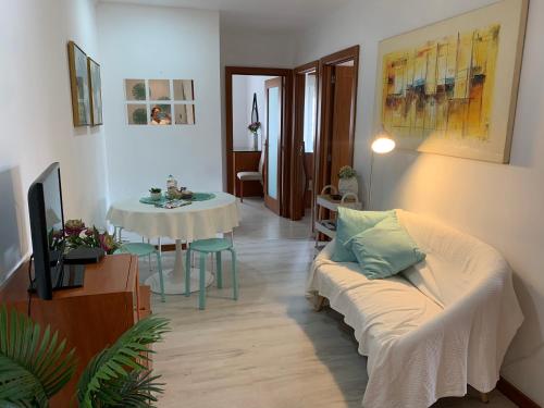 a living room with a couch and a table at Your sweet home near Aveiro! in Marco da Oliveirinha