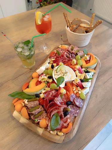 a platter of food on top of a wooden table at Micro Maison indépendante in Commelle-Vernay