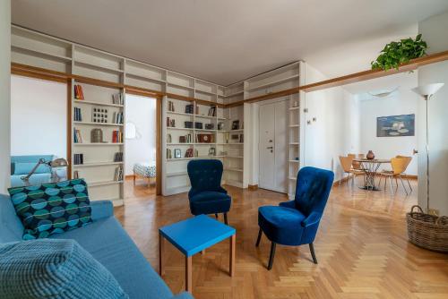 a living room with blue chairs and a blue couch at Terrazza di Flamy - WelcomeToRhome in Rome