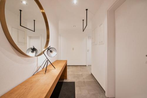 a hallway with a mirror and a wooden table at HEAVEN 7 SUITE - Garden Apartment with Private Whirlpool in Zillertal, presented by AlpenLuxus in Fügen