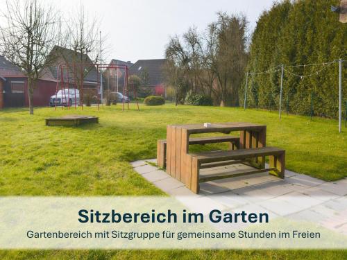 a picnic table and bench in a park at Stedesdorf, Ferienwohnung '9 und 40' in Stedesdorf