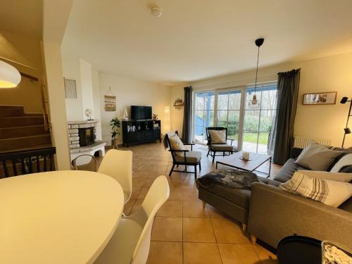 a living room with a couch and a table at Landhaus zum Strande - 44-08 in Kägsdorf