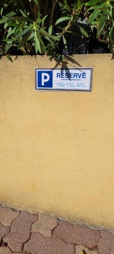 a parking sign on the side of a wall at Appartement de la Villa Del Sol in Pierrevert