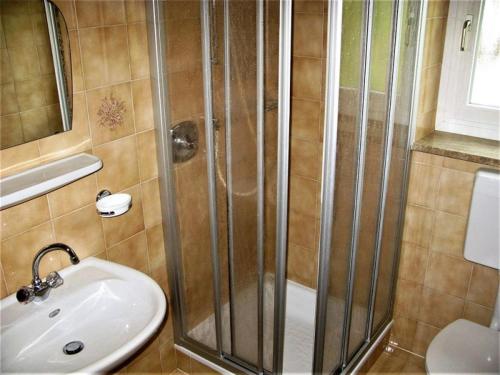 a bathroom with a shower and a sink at Pension Obermair in San Giovanni
