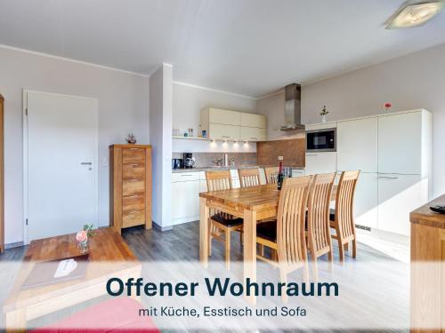 a kitchen and dining room with a wooden table and chairs at Peenemünde, Seglerhafen ST Brig 02 & 04 in Peenemünde