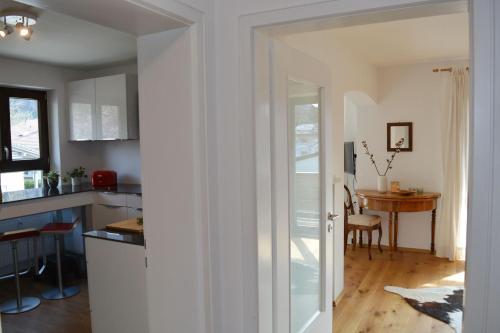 a kitchen and dining room with a table and a door at Zillibilly in Aschau im Chiemgau