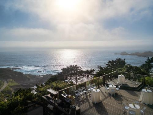 a balcony with tables and chairs and the ocean at Hyatt Vacation Club At Highlands Inn in Carmel