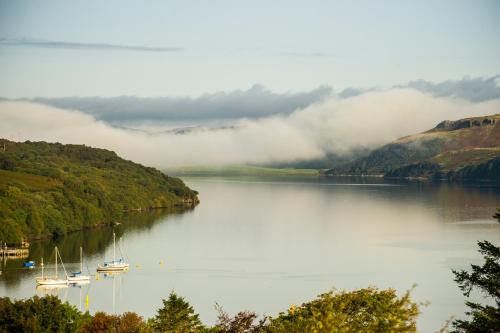 a view of a lake with boats in the water at Luxury Seaview Cottage by Fairy Pools 2 in Carbost