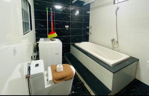 a bathroom with a tub and a sink and a toilet at Han Riverside in Da Nang