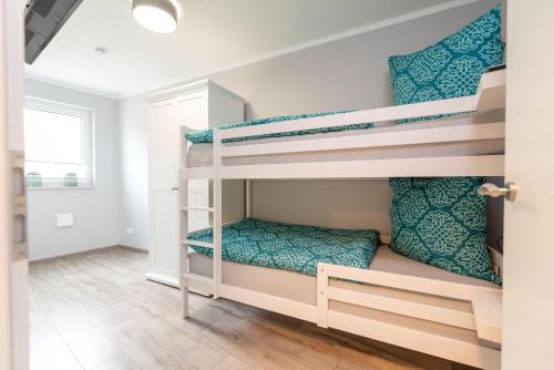 a bedroom with bunk beds in a house at Knuddi s Ferienhof, App 04 in Zempin