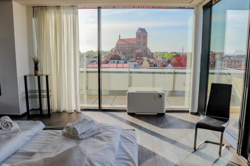a bedroom with two beds and a large window at Penthouse-Appartement Diamant - ABC591 in Wismar