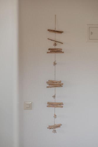 a wall with four wooden shelves on a wall at App Meerzeit in List