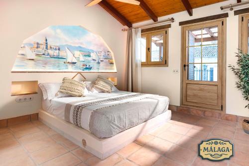 a bedroom with a bed with a painting on the wall at Mi Andalusia Hotel Experience in Málaga