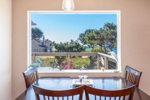 a dining room with a table and a large window at Lucky Ewe - Ocean View Retreat in Gualala