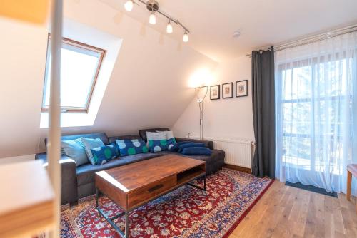 a living room with a couch and a table at Ackerweg, App 02 in Ueckeritz