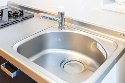 a stainless steel sink in a kitchen at Riverside Inn Hakata in Fukuoka