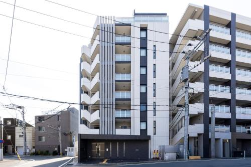an apartment building on the corner of a street at Riverside Inn Hakata in Fukuoka