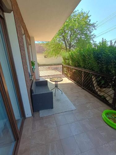 a patio with a table and stairs on a house at Maison de Veve in Svätý Michal