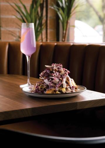 a plate of food and a glass of pink wine at Sechelt inn in Sechelt