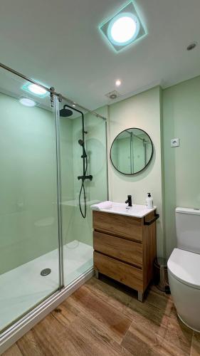 a bathroom with a shower and a sink and a toilet at Apartamento Elurra in Formigal