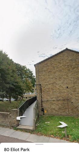 a brick building with a staircase next to a building at Bright Double Room near Lewisham Station in London