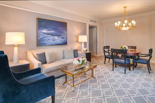 a living room with a couch and a table at Willard InterContinental Washington by IHG in Washington
