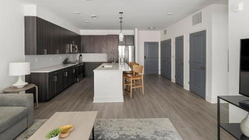 a kitchen and living room with a couch and a table at Landing at Station at Crestline - Mountain Brook in Mountain Brook