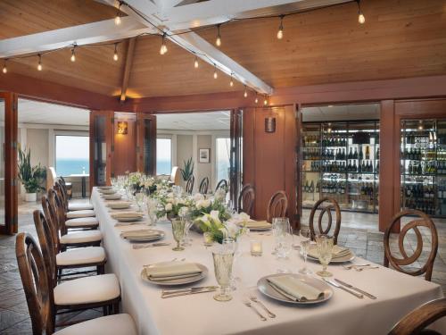 a long dining room with a long table and chairs at Hyatt Carmel Highlands in Carmel