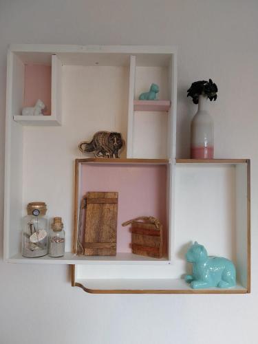 a shelf with a cat and other items on it at Ferienwohnung Alte Schule Ruhwarden in Butjadingen
