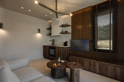 a living room with a couch and a table at PATHOS Private Villas - Adults Only in Samos