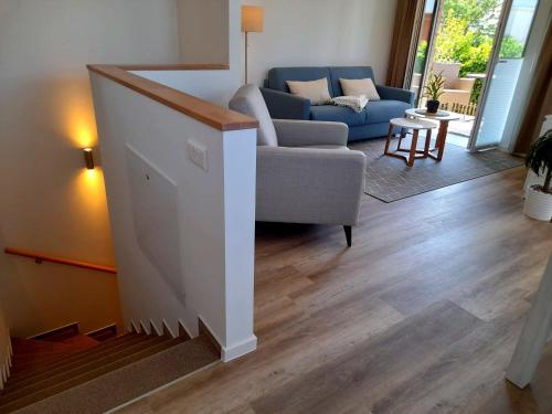 a living room with a couch and a chair at Seestern 01 in Grömitz