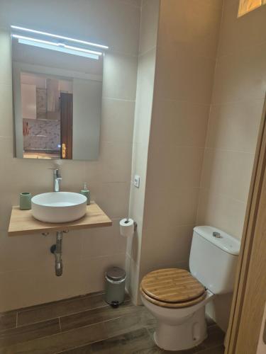 a bathroom with a toilet and a sink and a mirror at Juvica in Morro del Jable