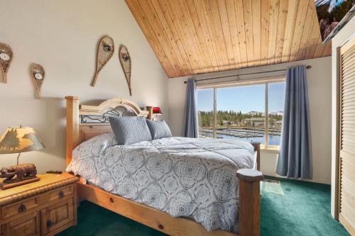 a bedroom with a bed and a window at Tahoe Keys Marina View - 3 BDR Desirable Community in South Lake Tahoe