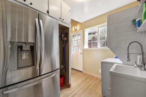 a kitchen with a stainless steel refrigerator and a sink at Zephyr Cove Zen - Hot Tub & Summer Pool in Zephyr Cove
