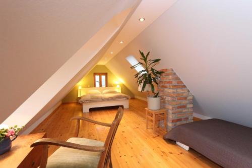 a room with a staircase with a table and a chair at Am Rieck "Fachwerkaus" in Zempin