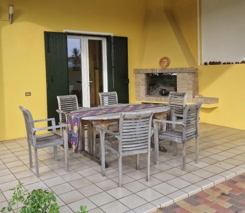 a dining room table and chairs on a patio at Cristina in Caleri