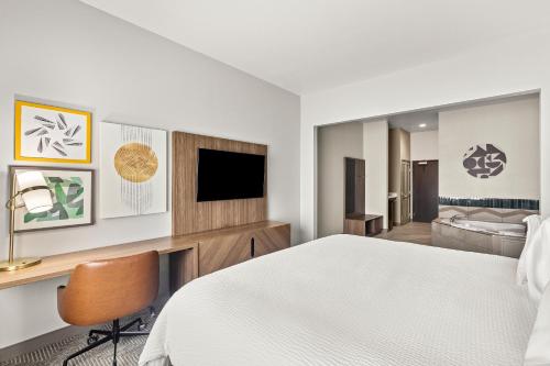 a hotel room with a bed and a flat screen tv at Holiday Inn Austin North by IHG in Round Rock