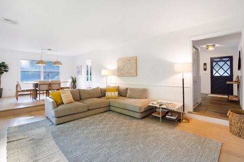 a living room with a couch and a table at Respite Ranch: Private Pool, Hot Tub, Beach Access in Mattituck