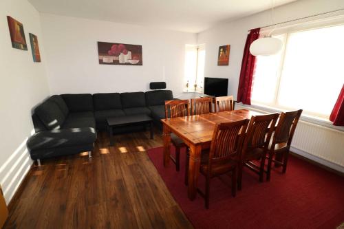 a living room with a couch and a table and chairs at Ferienwohnung in Reuterstadt Stavenhagen