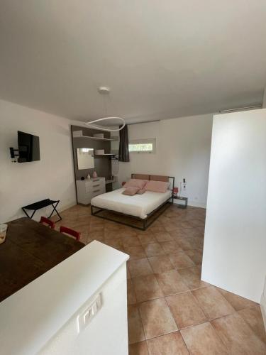 a bedroom with a bed in a room with tile floors at Villa Lidya Malpensa in Gallarate