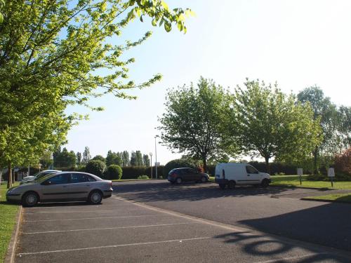 a parking lot with three cars parked in it at Premiere Classe Niort Est - Chauray in Niort