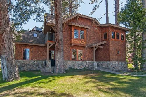 a house in the woods with a tree at West Lake Serenity with 180-Degree Lake Views in Homewood