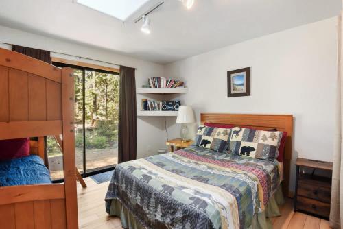 a bedroom with a bed and a sliding glass door at Elm Street Getaway Sleeps 8 in Tahoma