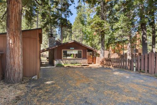 a house with a garage and a fence at Elm Street Getaway Sleeps 8 in Tahoma