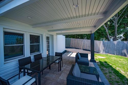 a patio with a table and chairs on it at Coastal Retreat: Waterfront, Deck, Awesome Views in Wading River
