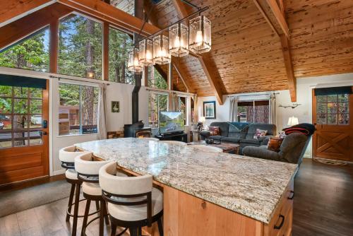 a kitchen and living room with a large island in a house at West Shore Haven - Near Beach & Outdoor Fun in Tahoma
