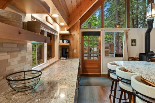 a kitchen with a counter and stools in a house at West Shore Haven - Near Beach & Outdoor Fun in Tahoma