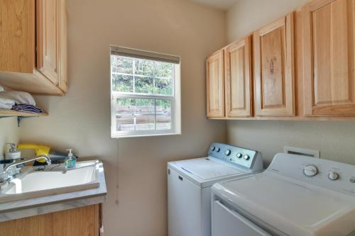 a laundry room with a washing machine and a sink at Mountain-View Conifer Gem Near Hiking and Fishing in Conifer
