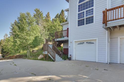 a house with a driveway and a garage at Mountain-View Conifer Gem Near Hiking and Fishing in Conifer