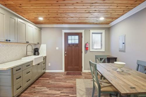 a kitchen with a table and a wooden ceiling at Alpine Chalet Nature Lovers Rejoice Chic 4 BDR in Alpine Meadows